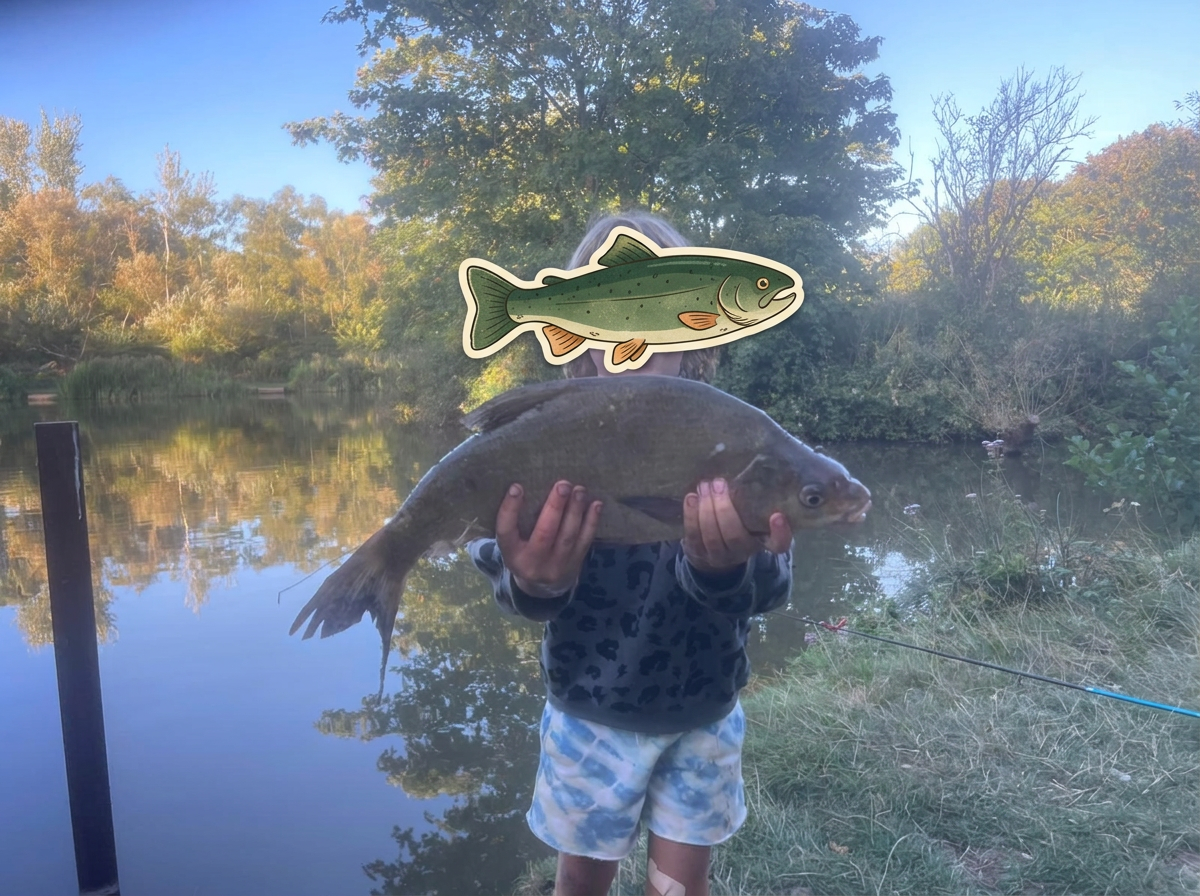 Hendricks holding a large fish beside the water, with an illustrated trout covering his face for privacy